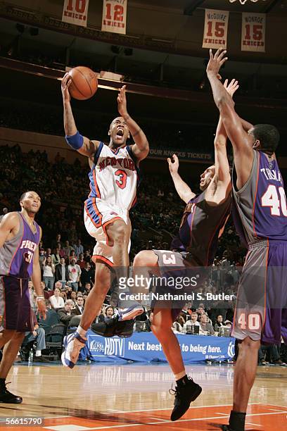 Stephon Marbury of the New York Knicks drives to the basket against Steve Nash and Kurt Thomas of the Phoenix Suns on January 2, 2006 at Madison...