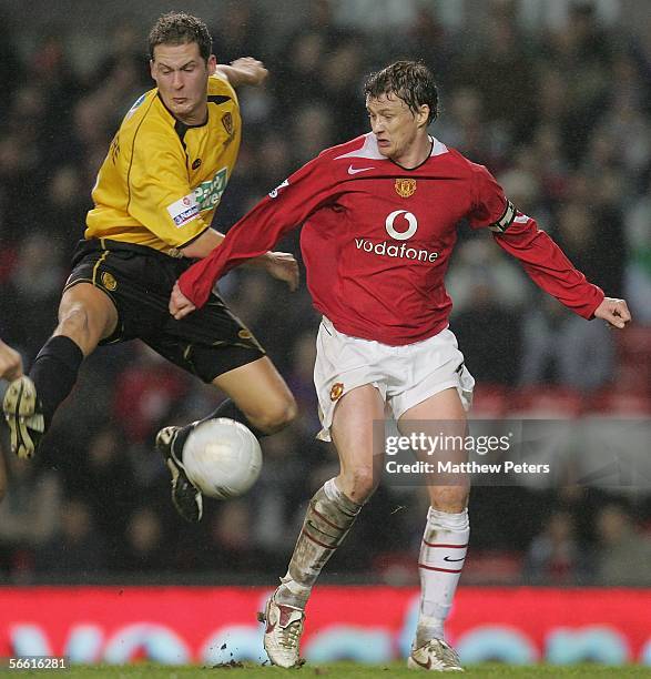 Ole Gunnar Solskjaer of Manchester United clashes with Jake Sedgemore of Burton Albion during the FA Cup Third Round replay match between Manchester...