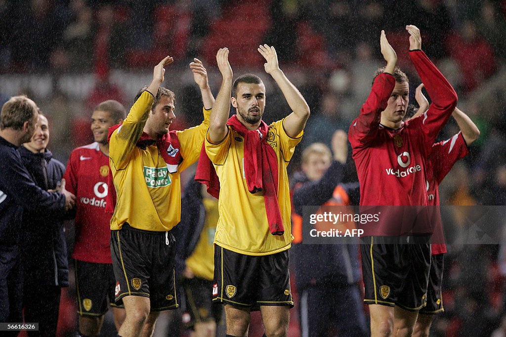 Burton Albion players applaud their supp