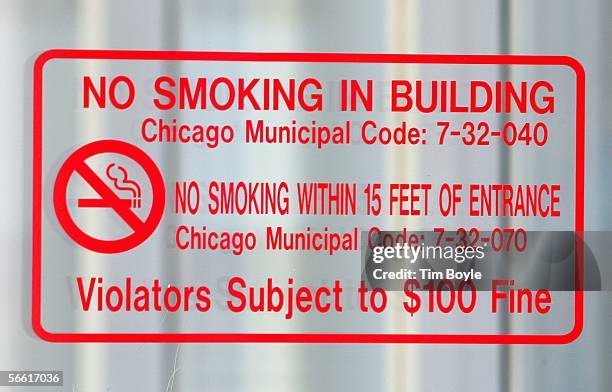 No Smoking In Building" sign explaining Chicago's new smoking rules is posted on a door at O'Hare International Airport January 18, 2006 in Chicago,...