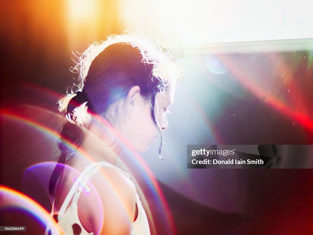 Girl in light with sun flare