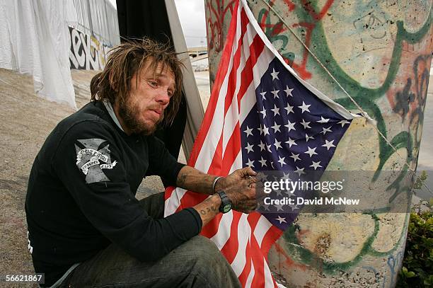 Man who goes by the name "Pepper" sits near his camp on the sloping concrete banks of the Los Angeles River on January 18, 2006 in Los Angeles,...