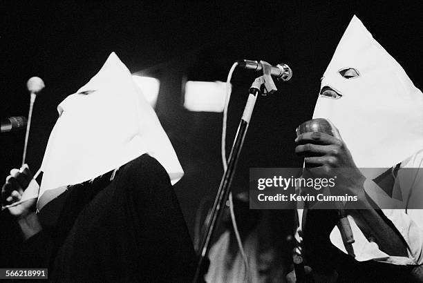 Singers Michael Riley and David Hinds performing, in Ku Klux Klan hoods, with English roots reggae band Steel Pulse at the Electric Circus,...