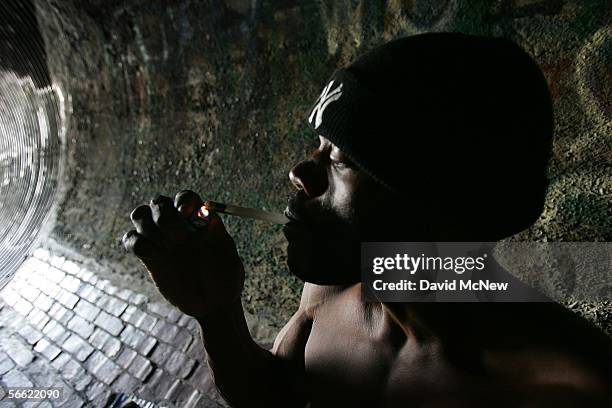Donald Rayfield, known on the street as "Detroit", smokes crack cocaine in an underground storm drain on January 18, 2006 in Los Angeles, California....