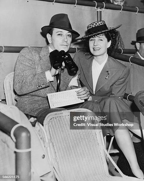 George Raft, American actor and dancer, and Norma Shearer, Canadian actress, attend the horse races at Santa Anita racetrack, Arcadia, California,...