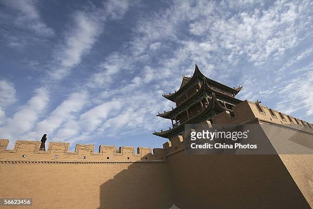 Visitor walks atop the Jiayuguan Pass of Great Wall at sunset on January 18, 2006 in Jiayuguan of Gansu Province, northwest China. The Great Wall,...