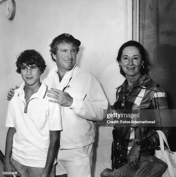 American singer, actor, talk show host, and empresario Merv Griffin stands between his son Tony and his wife, future internet quiz entrepreneur...