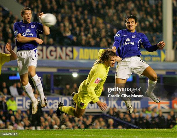 Tim Cahill of Everton beats Matt Lawrence of Millwall during the FA Cup Third Round Replay match between Everton and Millwall at Goodison Park on...