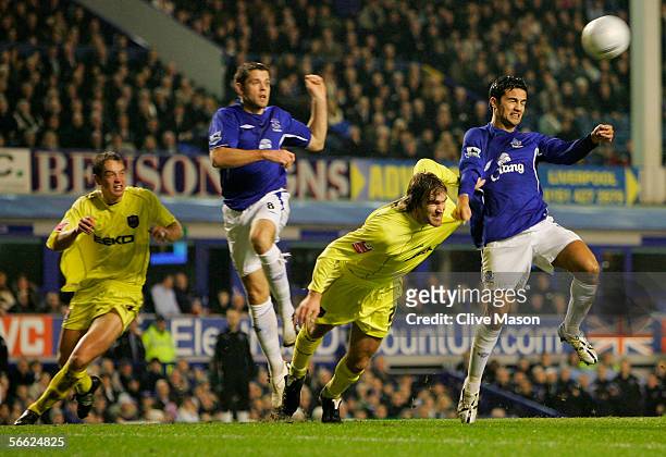 Tim Cahill of Everton holds off Matt Lawrence of Millwall during the FA Cup Third Round Replay match between Everton and Millwall at Goodison Park on...