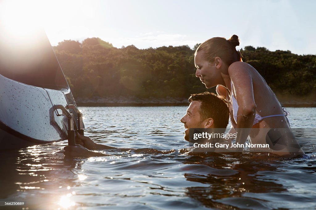 Happy young couple playing in the sea.