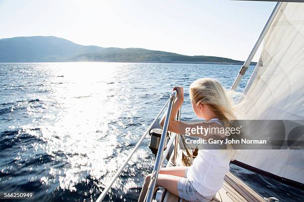 young girl enjoys wind in her hair on yacht. - kid sailing imagens e fotografias de stock