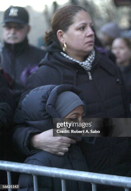 Alyssa Vasquez, eight-years-old, and her mother, Gilicel Luperena, wait-in-line, outside the Ortiz Funeral Home, with other people who read about the...