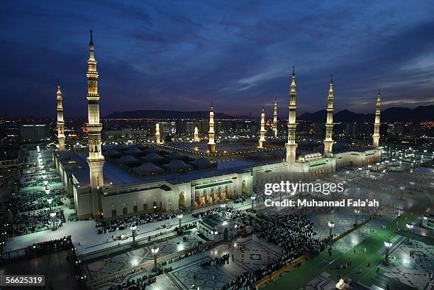 Muslim pilgrims pray near the Prophet Muhammad mosque on January 19, 2006 in the holy city of Medina, Saudi Arabia. Saudi authorities are turning...