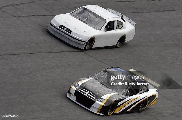 Bret Bodine, driver of the NASCAR winged version of the car of tomorrow leads Kyle Petty, driver of the Petty Enterprises spoiler version Car of...