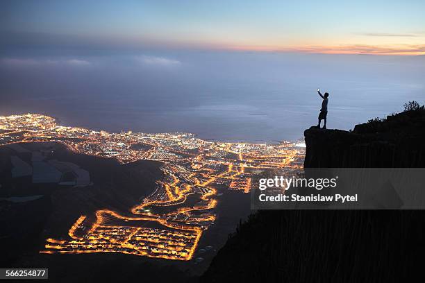 man with mobile device at night city view - spain city stock pictures, royalty-free photos & images