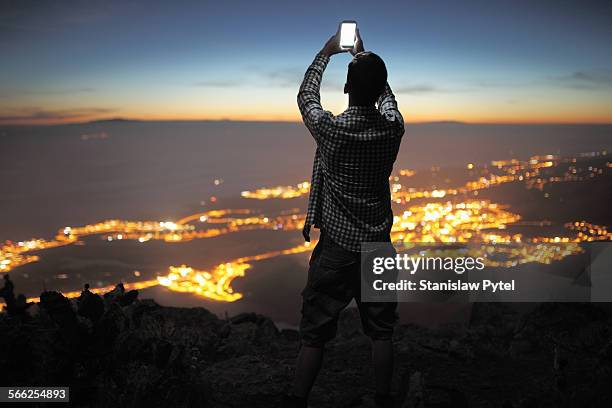 man with mobile device at night city view - virtualitytrend stockfoto's en -beelden