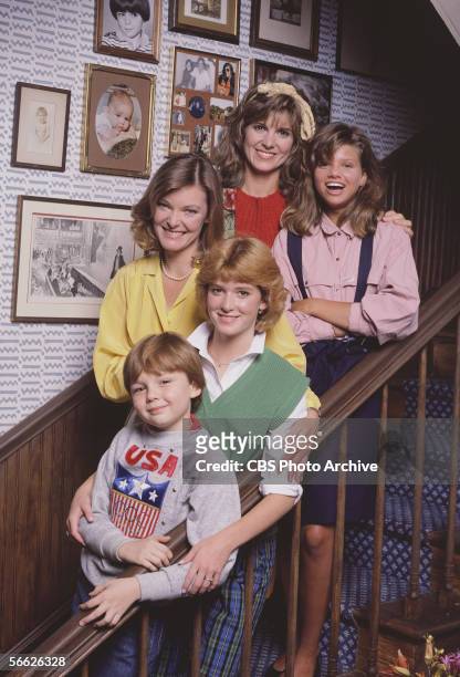 Promotional portrait of the cast of the CBS television sitcom 'Kate & Allie,' who pose together on a staircase, New York, New York, 1986. From top...
