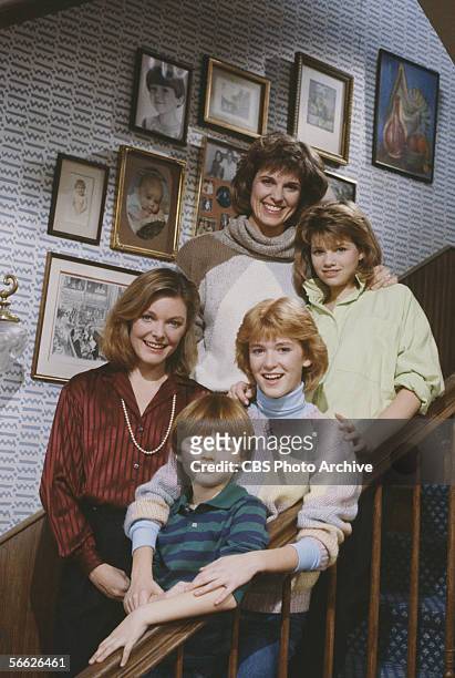 Promotional portrait of the cast of the CBS television sitcom 'Kate & Allie,' who pose together on a staircase, New York, New York, 1984. From top...