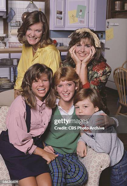 Promotional portrait of the cast of the CBS television sitcom 'Kate & Allie,' who pose together around a couch near the kitchen, New York, New York,...