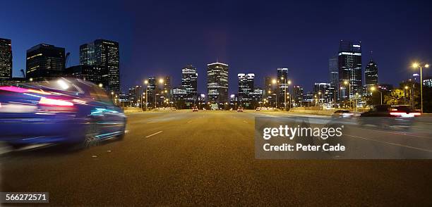 cars at night on highway , city scape perth . - perth australien stock-fotos und bilder