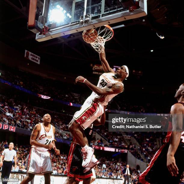 LeBron James of the Cleveland Cavaliers dunks against Antonie Walker of the Miami Heat on December 17, 2005 at Quicken Loans Arena in Cleveland,...