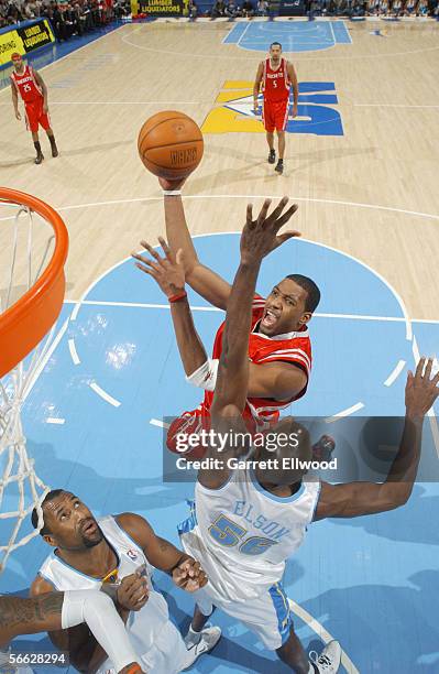 Tracy McGrady of the Houston Rockets shoots against Francisco Elson of the Denver Nuggets on December 23, 2005 at the Pepsi Center in Denver,...