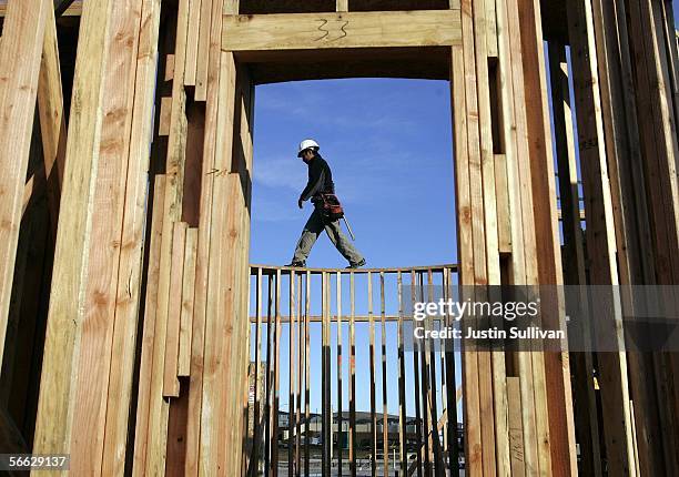 Construction worker walks across the framing on a new home under construction January 19, 2006 in Dublin, California. The Commerce Department...