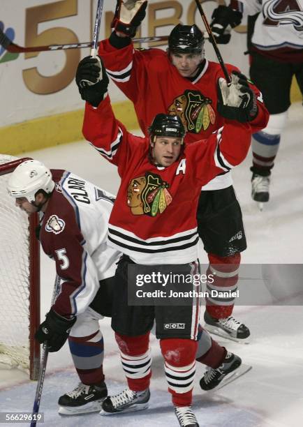 Kyle Calder of the Chicago Blackhawks celebrates his goal 17 seconds into the first period with teammate Radim Vrbata as Brett Clark of the Colorado...