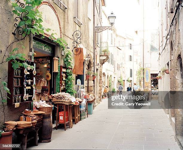 typical italian street with shops - grosseto stock-fotos und bilder