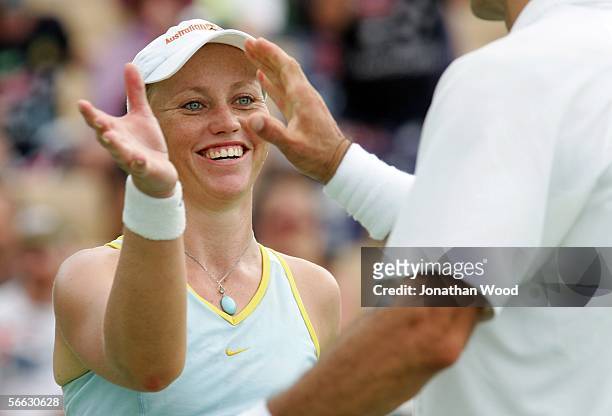 Bryanne Stewart of Australia celebrates with Jim Thomas of the USA in their doubles match against Trudi Musgrave and Nathan Healey of Australia...