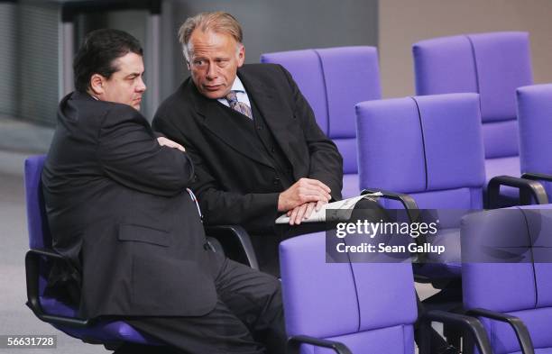 Current German Minister of the Environment Sigmar Gabriel and his predecessor Juergen Trittin chat prior to debates at the Bundestag over the roll of...