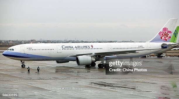 An aircraft of Taiwan-based China Airlines arrives at the tarmac of Shanghai Pudong International Airport for non-stop cross-Straits flight on...