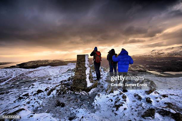 hikers on the summit of loughrigg fell - loughrigg fell stock pictures, royalty-free photos & images