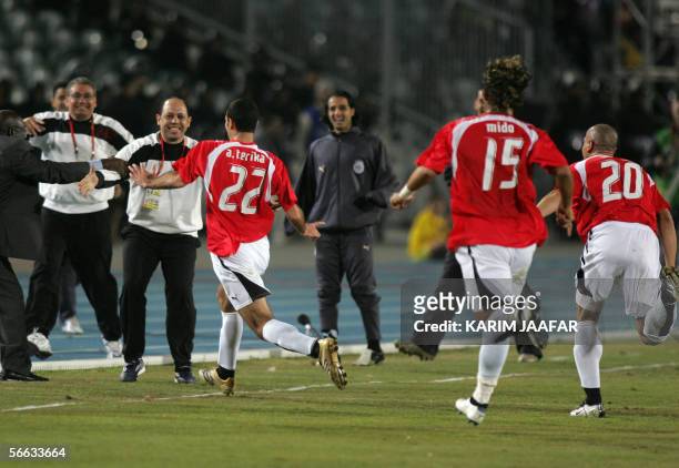 Egyptian players Mohammed Abu Terika , Ahmed "Mido" Hossam , and Wael Gomaa celebrate after scoring the second goal against Libya during their...