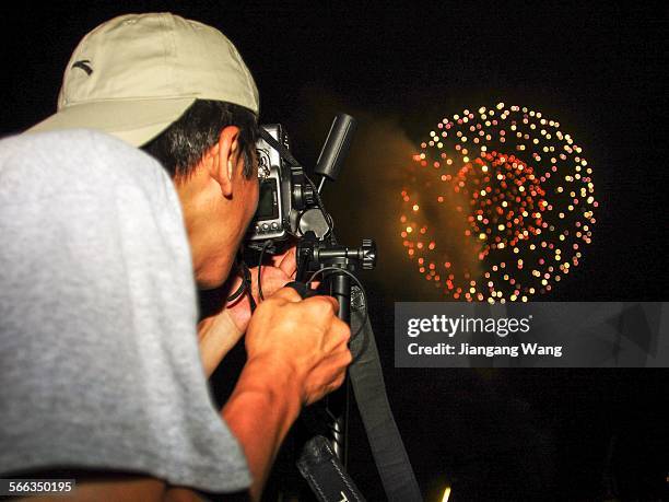 Yokosuka, Kanagawa Prefecture, Japan A man is taking pictures of firework show near the US Navy basement in Yokosuka.