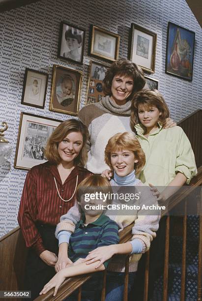 Promotional portrait of the cast of the CBS television sitcom 'Kate & Allie,' who pose together on a staircase, New York, New York, 1984. From top...