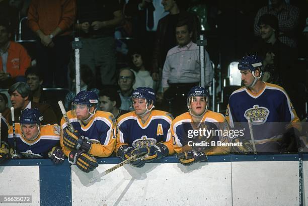 Members of the LA Kings professional hockey team watch the on-ice action from the bench, October 1986. Visible players include coach Pat Quinn ,...