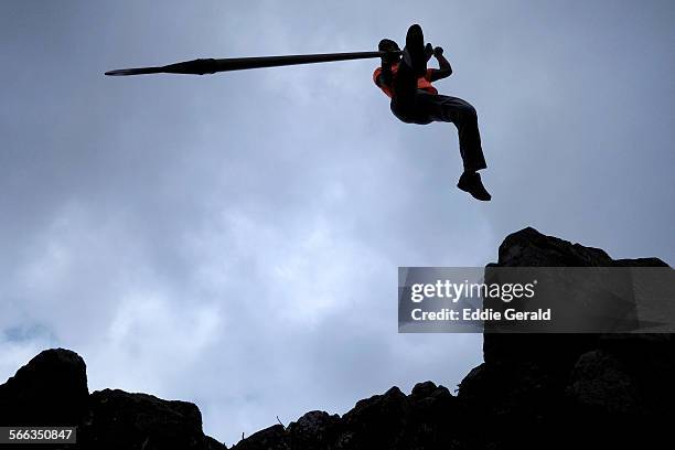 Person practicing the traditional Sheperd's Jump in the deep ravines of the Teno mountains in Isla Baja northern part of The Canary Island of...