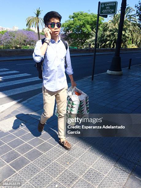 Man with a smartphone on the street, Valencia, Spain May 20, 2015