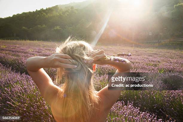 caucasian woman admiring field of flowers - young women no clothes stock pictures, royalty-free photos & images