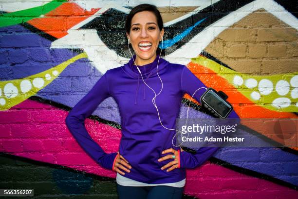 hispanic runner smiling near graffiti wall - graffiti hintergrund stock pictures, royalty-free photos & images