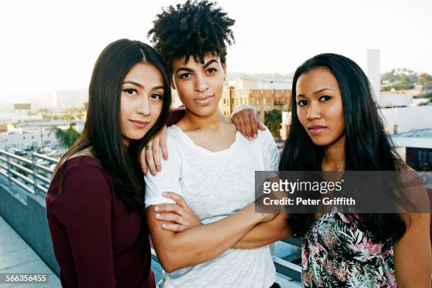 serious women standing on urban rooftop - three people portrait stock pictures, royalty-free photos & images
