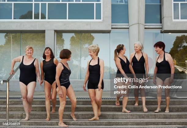 older caucasian women wearing black bathing suits at pool - woman swimsuit happy normal stock pictures, royalty-free photos & images