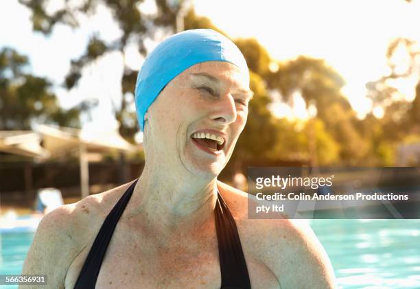 older caucasian woman wearing swimming cap in pool - woman swimsuit happy normal stock pictures, royalty-free photos & images