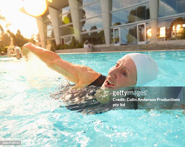 Older Caucasian woman swimming in pool