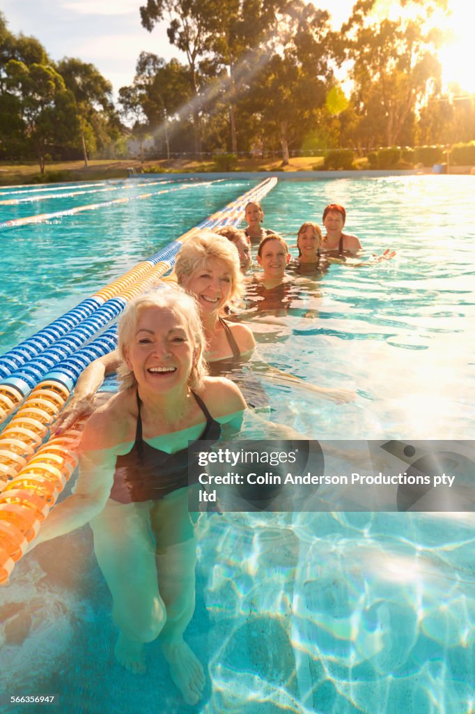 Older Caucasian women smiling in pool