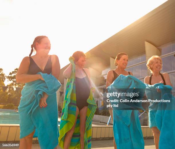 older caucasian women drying off at pool - envuelto en una toalla fotografías e imágenes de stock