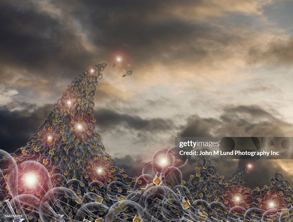 Illuminated light bulbs forming path to sky