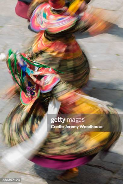 blurred view of performers dancing in traditional dress - trongsa district fotografías e imágenes de stock