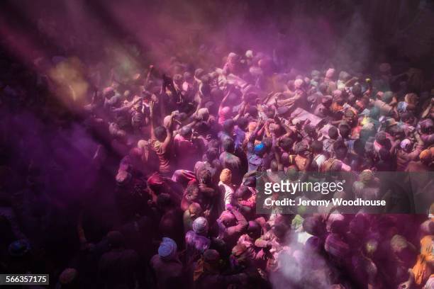 high angle view of revelers celebrating holi festival - crowd surfing stock-fotos und bilder